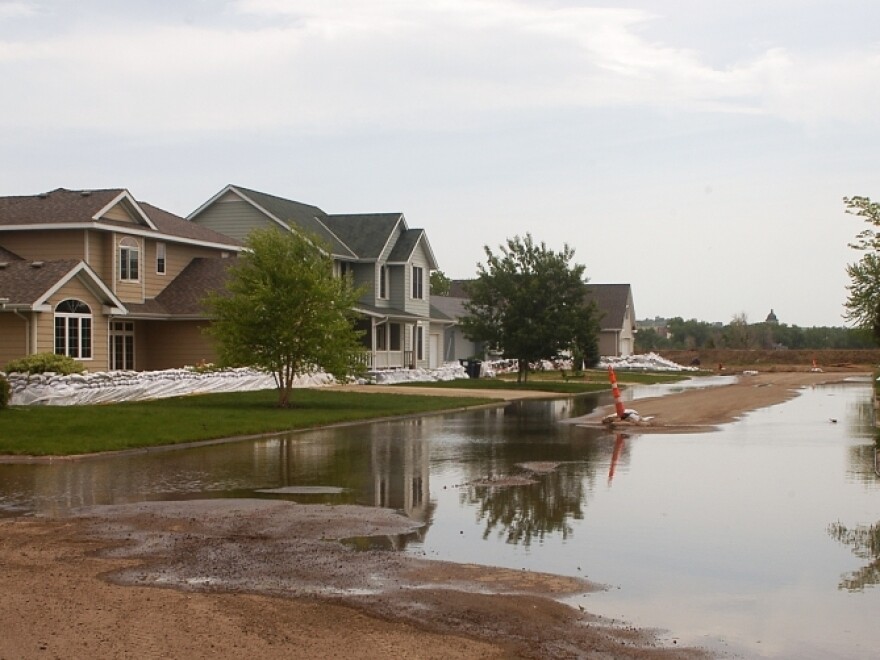 Water pools in the street in front of sandbagged homes in Pierre, S.D., Thursday. South Dakota's governor has urged some residents to evacuate from three cities considered early trouble spots as officials brace for a prolonged period of Missouri River flooding