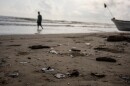 Clumps of oil residue lie on the shore after fishing outings were suspended because of an oil spill that Mexican authorities said originated from an unidentified vessel and two natural oil seeps along the Gulf coast in Salinas, Mexico, Thursday, March 26, 2026.