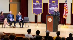 WIU President Kristi Mindrup addresses the crowd at the University Assembly. She was joined on stage by (from left to right) Ketra Roselieb, Vice President for Finance and Administration; Justin Schuch, Vice President for Student Success; and Mark Mossman, Provost and Academic Vice President.