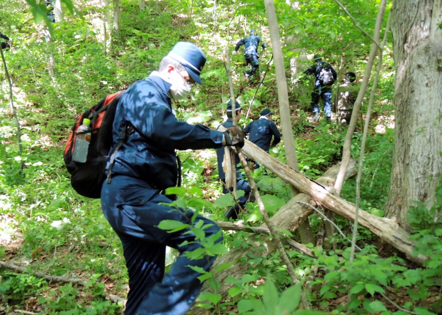 Police officers search for a 7-year-old boy in the mountains of Hokkaido, where he went missing after his parents said they left him alone temporarily as a punishment.