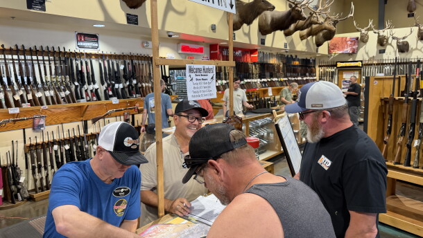 Matt Dusek, left, indoor range manager at Sprague's Sports in Yuma, helps weigh a dove as part of the annual "Big Breast" competition during dove hunting season.