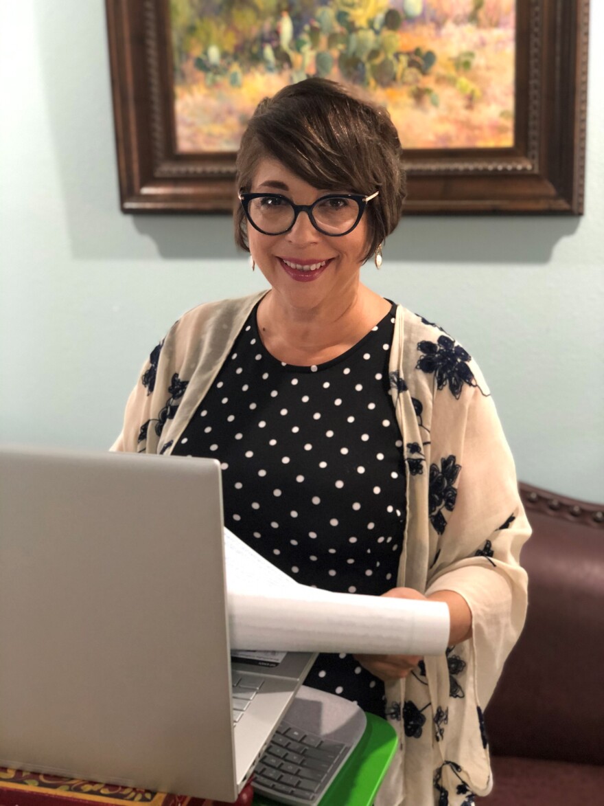 Photo of Jordana Barton at her computer in her home office