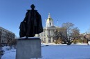Franklin Pierce looms over a snowy State House plaza.