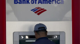 A customer uses an ATM at a Bank of America location in San Francisco, Monday, April 24, 2023. Bank of America is being ordered to pay more than $100 million to customers for double-dipping on some fees imposed on customers, withholding reward bonuses explicitly promised to credit card customers, and misappropriating sensitive personal information to open accounts without customer knowledge or authorization. (AP Photo/Jeff Chiu, File)