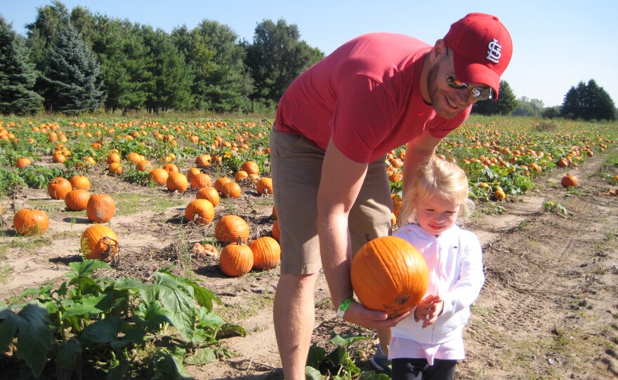 Kevin Coppinger took his nearly 3-year-old daughter, Mae, to choose a pumpkin at Waldoch Farm. The farm added a corn maze about five years ago. Owner Doug Joyer says adding such attractions has allowed him to live solely off income from the farm.