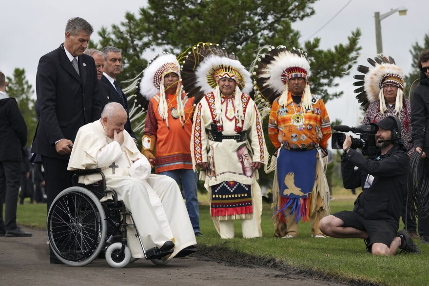 Pope Francis prays in front of Indigenous chiefs at the Ermineskin Cree Nation Cemetery in Maskwacis, Alberta, on Monday during his papal visit across Canada.
