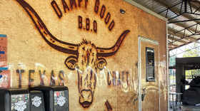 Nick Dampf stands in front of the barrel-shaped smokers at his Michelin award-winning, Texas-style barbecue food truck in Cary, N.C.