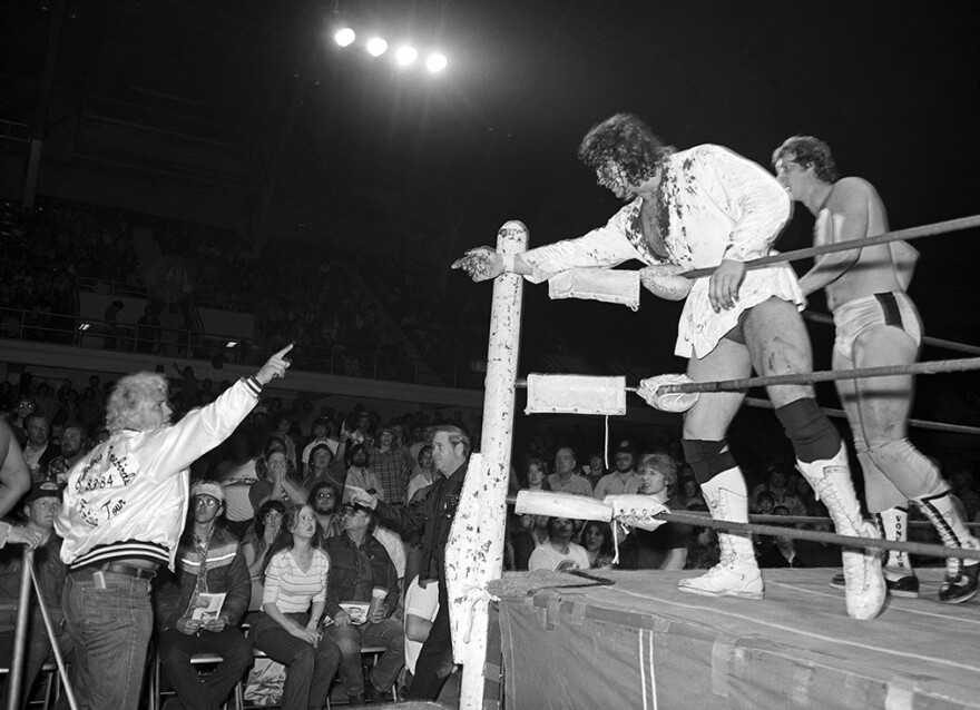 At a match at Will Rogers Coliseum in 1982 or '83, an injured Kerry Von Erich in the ring points to Buddy Roberts (aka Dale Hay), who's wearing a Freebirds jacket — the longtime rivals of the Von Erichs. David Von Erich is behind Kerry.