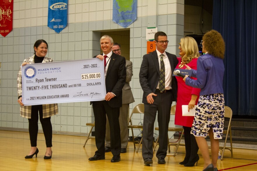 Ryan Towner, third from right, reacts after learning he is receiving the $25,000 cash award. Indiana Secretary of Education Katie Jenner is second from right.