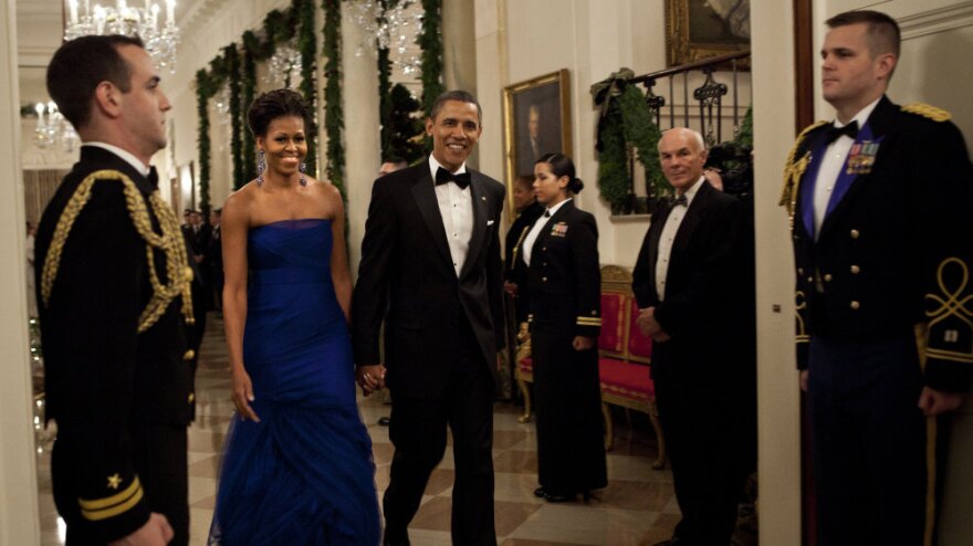 For a formal gathering, Michelle Obama demonstrates her sophistication in this elegant deep blue gown.