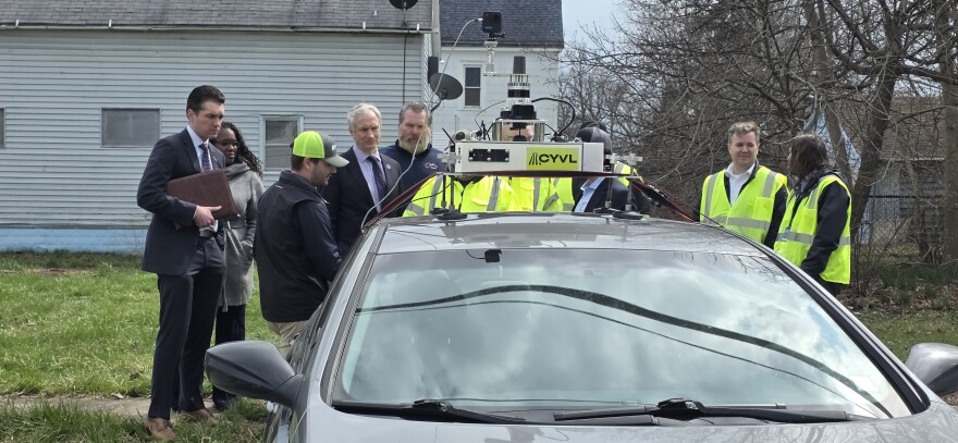 City officials observe technology from CYVL that will be used in road assessments.