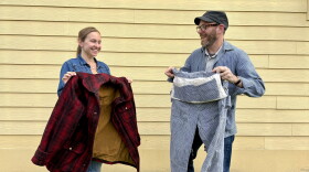 Maddie Boardman of the clothing store Mahshu and Billings Farm & Museum curator Sherlock Terry hold up examples of vintage workwear.
