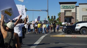 Protestors march across 4th Avenue on Saturday for the No Kings rally.