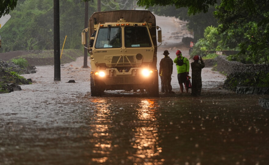 Members of the Hawaiʻi Army National Guard work with other emergency officials as rainwater from nearby Hurricane Nolo floods a section of Māmalahoa Highway Saturday, Sept. 26, 2026, near Naʻālehu, Hawaiʻi Island.