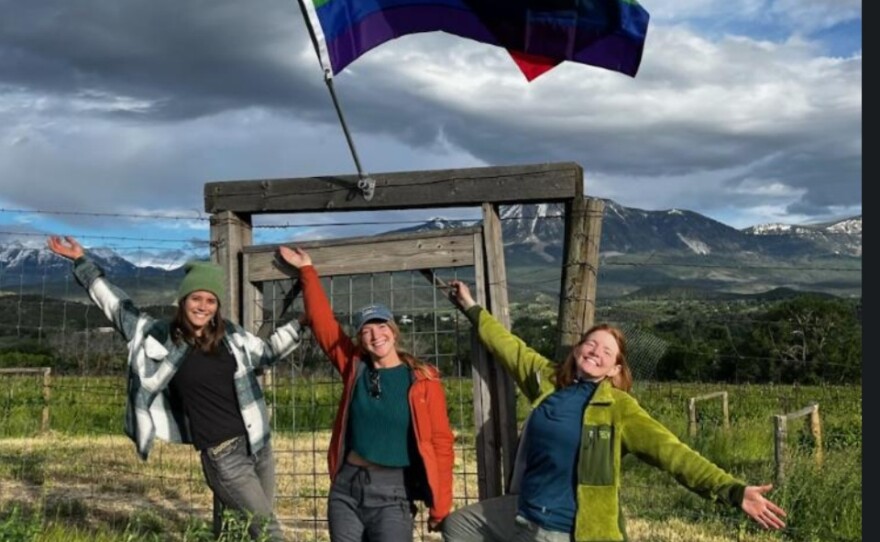 A volunteer hangs a “Pride Flag” on a Town of Paonia light pole in 2022.