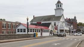 This 2017 photo shows a view past a bridge over the Souhegan River to downtown Milford, New Hampshire