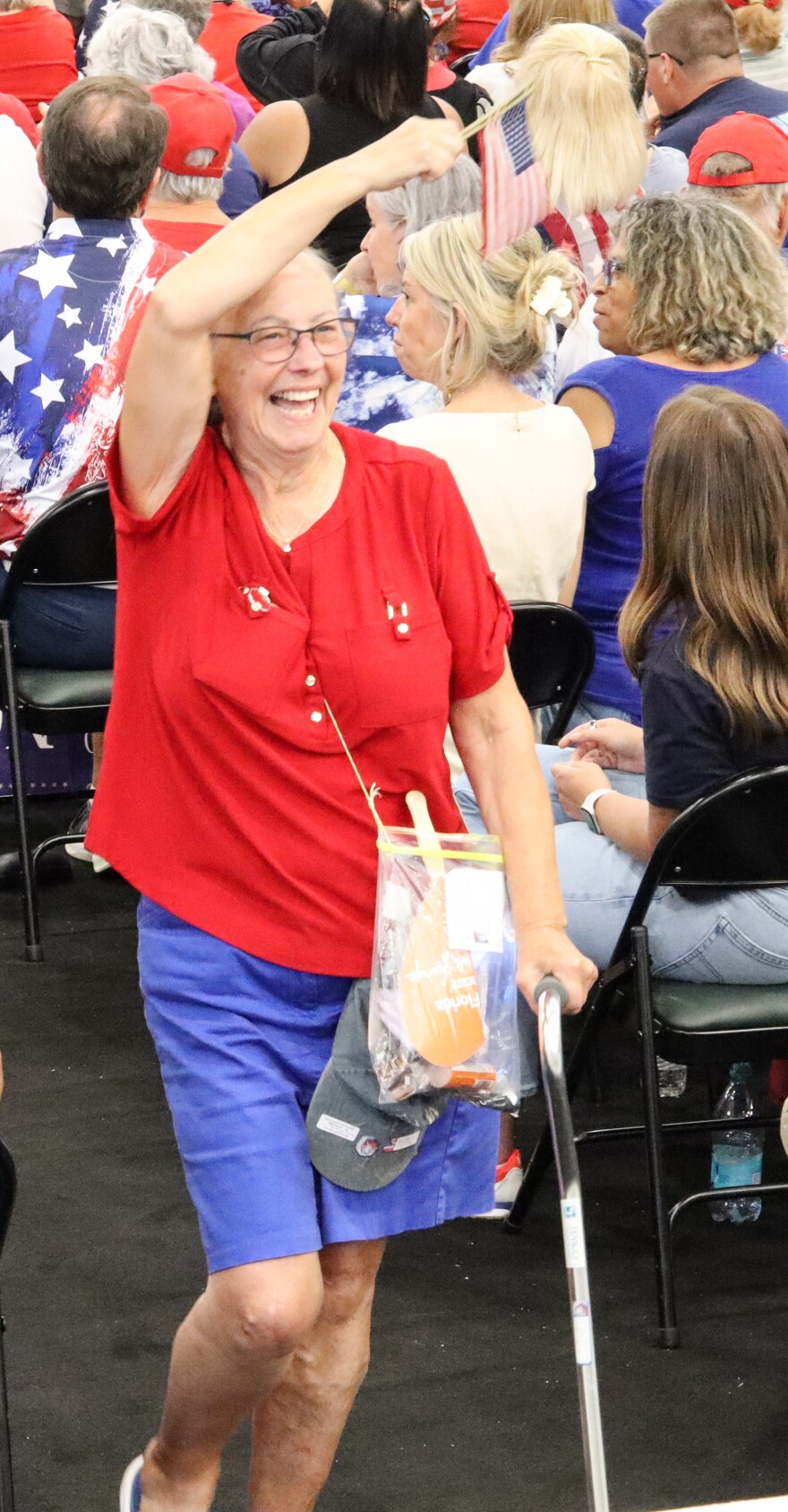 Shortly before President Trump arrived, a woman with a cane walked around the gym waving small American flags and smiling with excitement.