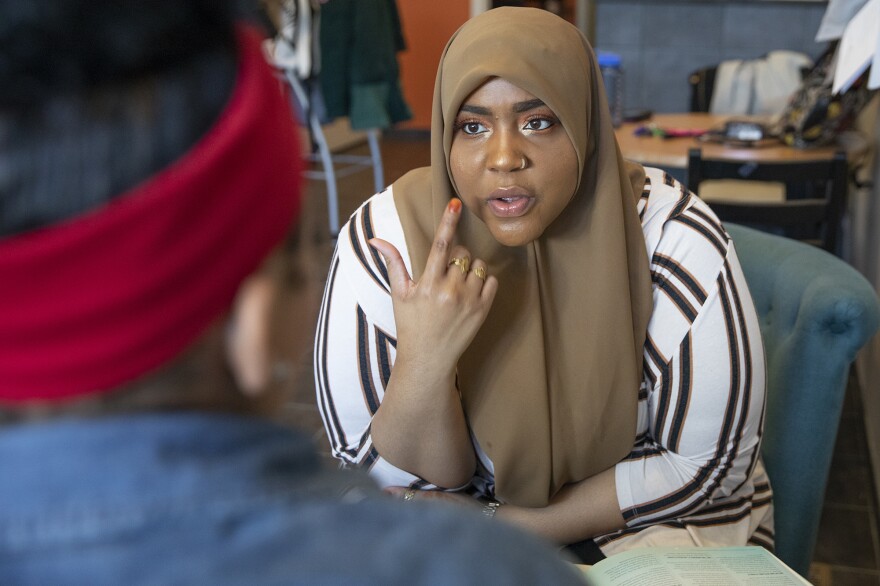 Ayesha Uqdah, a community health worker with Maternity Care Coalition, meets with her client Chaffon Williams at the coalition office in the Mantua neighborhood of Philadelphia in March. Uqdah helps women with high-risk pregnancies get the care and education they need.
