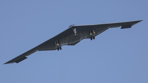 A B-2 bomber flying in the sky. 