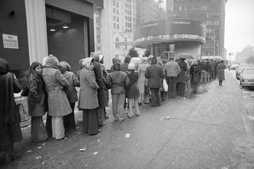 Despite sub-freezing temperatures and rain, a crowd waits in line outside the Paramount Theater in New York City for a showing of "The Exorcist" in February 1974.