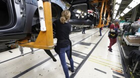 Vehicles go through the assembly line at a General Motors assembly plant in Lansing, Mich., on Feb. 21. GM is assessing the feasibility of converting its plants to make medical equipment.