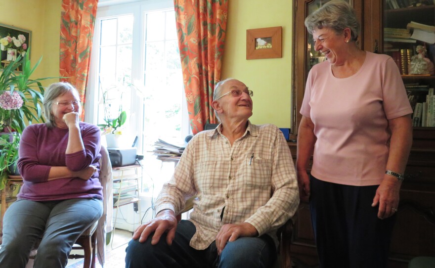 Elisabeth Schaible (left) enjoys a laugh with Andrew Beldowski and Anne Guillemot. Guillemot sometimes hosts the French conversation club — where newcomers can practice French — at her home in the village of Perret.