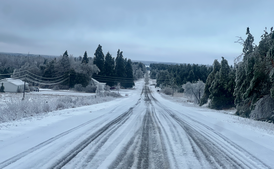 Snow and ice encase power lines and trees — and cover Polish Line Road in Cheboygan on Sunday, March 30, 2025. (Photo: Michael Livingston/IPR News)