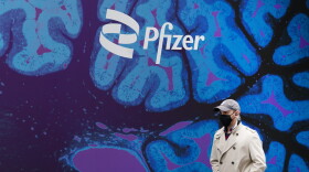 A man walks by Pfizer headquarters in New York.
