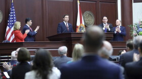 Gov. Ron DeSantis, center, is applauded during his state of the state address to a joint session on Tuesday Jan. 14, 2020, in Tallahassee, Fla. (AP Photo/Steve Cannon)