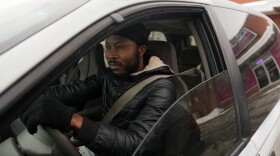 a man is pictured sitting in a car