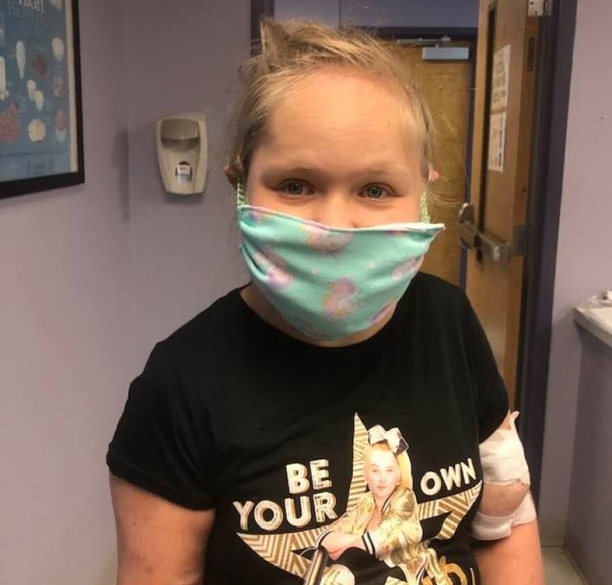 Mary Ashley tries on a mask given to her by a friend.