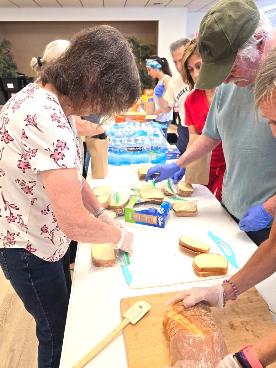 Adam's Angels volunteers prepare food for distribution to those in need.