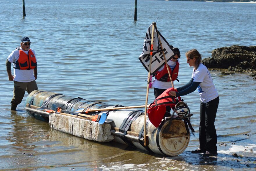 From left: Rod Hunt, 65, his daughter Kelsey Hunt, 34, and Melissa DeSa pull "The Percival Hunt" ashore after winning the fastest boat in 13 minutes, at Cedar Key's Repurpose-It-Regatta on Saturday. (Caitlin Ostroff/WUFT News)