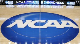 FILE - In this March 18, 2015, file photo, an NCAA logo is displayed at center court as work continues at The Consol Energy Center in Pittsburgh.