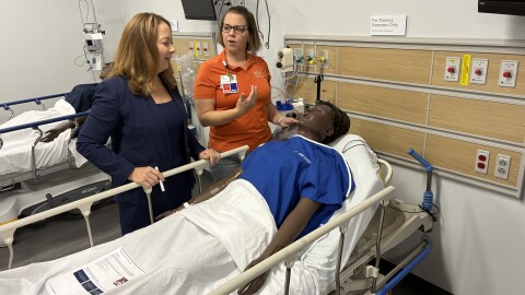 Erin Keister, chief nurse executive for HCA's Capital Division (left), speaks with clinical educator Leah Wagner over a mannequin patient at LewisGale Regional Health System's new clinical simulation center. 