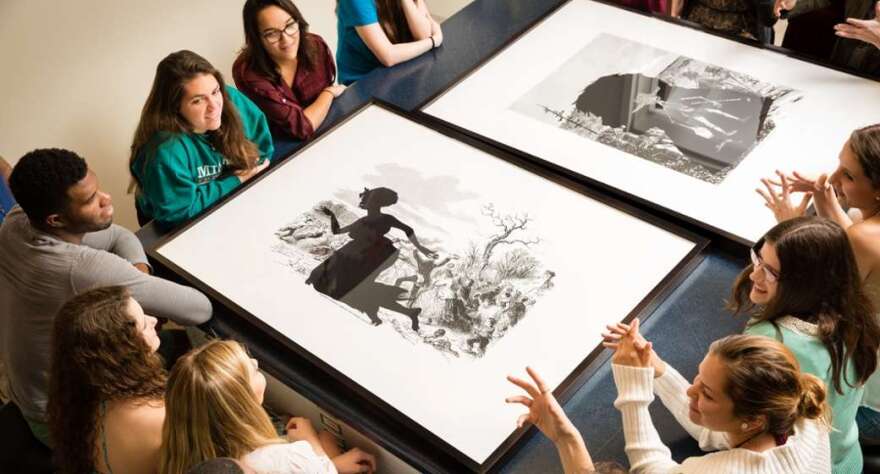 Students discuss the work of Kara Walker during class at the Cornell Fine Arts Museum, Rollins College. Photo: Scott Cook.                                       Kara Walker, Exodus of Confederates from Atlanta from Harper's Pictorial History of the Civil War (Annotated), (detail), 2005, Offset lithography and silkscreen, 39 x 53 in., The Alfond Collection of Contemporary Art, Gift of Barbara R'68 and Theodore R'68 Alfond © 2014 Kara Walker Cornell Fine Arts Museum. Photo: Scott Cook