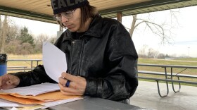 Rayne Bennett flips through her folder filled with journal entries, complaint forms and medical services requests. 
