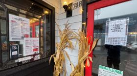 The exterior of a restaurant, decorated with an autumn theme. A sign on the door reads: "CLOSED UNTIL FURTHER NOTICE."