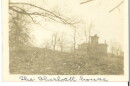 A sepia-toned photograph of a building from a distance.