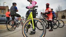Cyclists gather and chat near the 18th and Vine District's Gregg/Klice Community Center in March, where the Major Taylor Cycling Club of Kansas City prepared for its first Monday night group ride of 2022. (Carlos Moreno/KCUR)