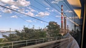 Amtrak's Northeast Regional line rolls through Connecticut past a gas power plant.