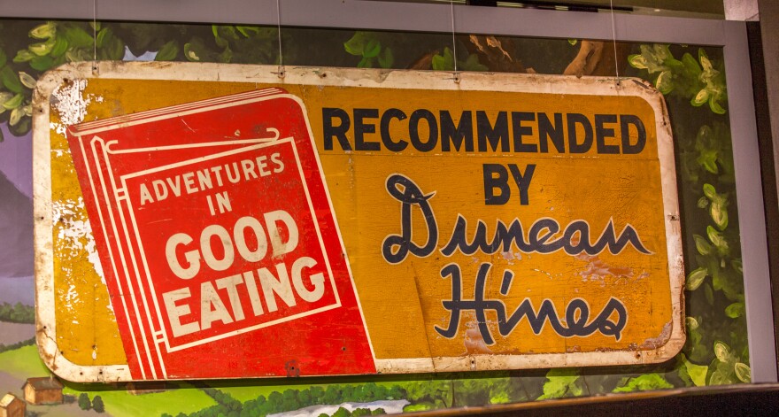 A roadside sign advertising Duncan Hines' <em>Adventures in Good Eating</em> is on display at the Kentucky Museum at Western Kentucky University.