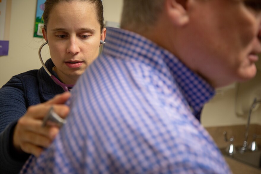 Dr. Katrina Burke checked Randall Phillips during an exam at Mercy Hospital in Fort Scott, Kan., in December. "Up in the city, a lot of doctors don't do everything like we do," Burke said of the variety of patients she sees as a family practice doctor who also delivers babies.