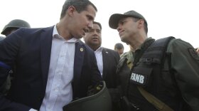 Venezuelan opposition leader and widely recognized interim President Juan Guaido talks with a military officer in Caracas last week.