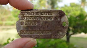 This Feb. 13 photo provided by Genevieve Cabrera shows World War II Pfc. Thomas E. Davis' Army dog tag that was found in a farm field on Saipan in early 2014.