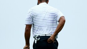 Tiger Woods rubs his back Aug. 8 during the second round of the 96th PGA Championship at Valhalla Golf Club in Louisville, Ky.