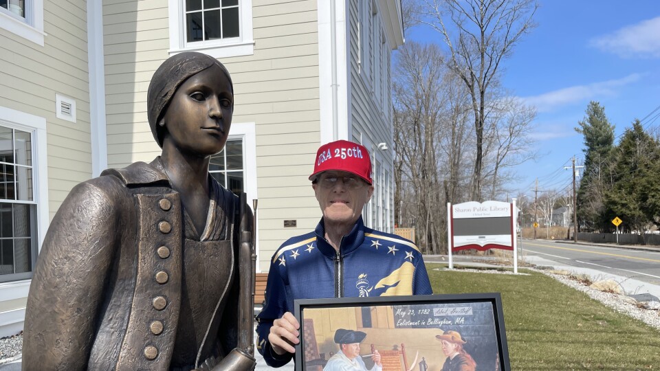 Historian Steve Connolly poses with a statue of Deborah Sampson in Sharon, Mass.