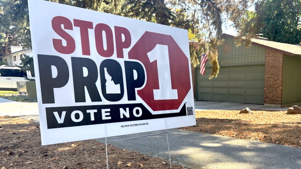 A close up of a yard sign against Proposition one. 