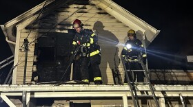 A firefighter on a roof