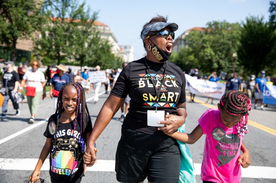 Shirley Thompson of D.C. with her great grandchildren, Laloni Thompson, 7, left, and Harley Thompson, 8.